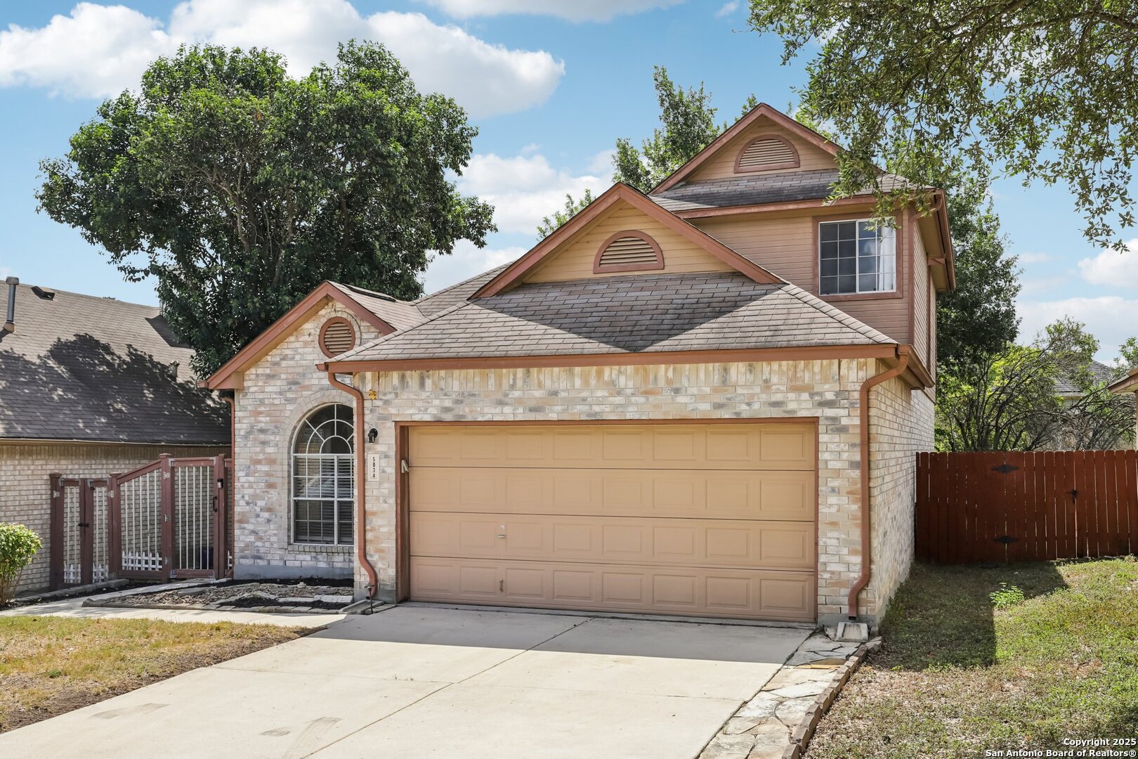 5834 Spring Crossing San Antonio, TX 78247 - Photo 2 of 29 a front view of a house with a garage