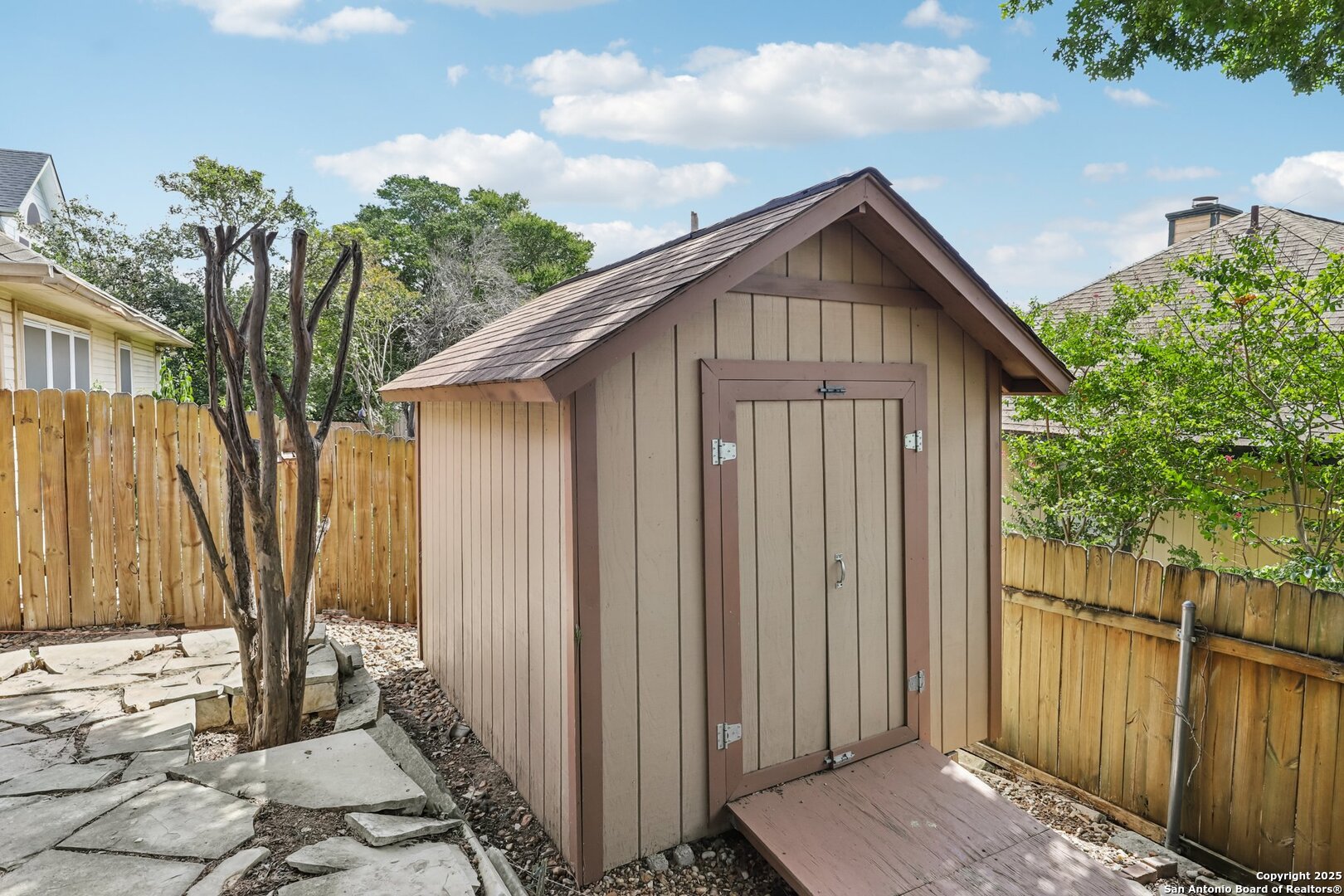 5834 Spring Crossing San Antonio, TX 78247 - Photo 26 of 29 a view of a house with wooden fence next to a yard