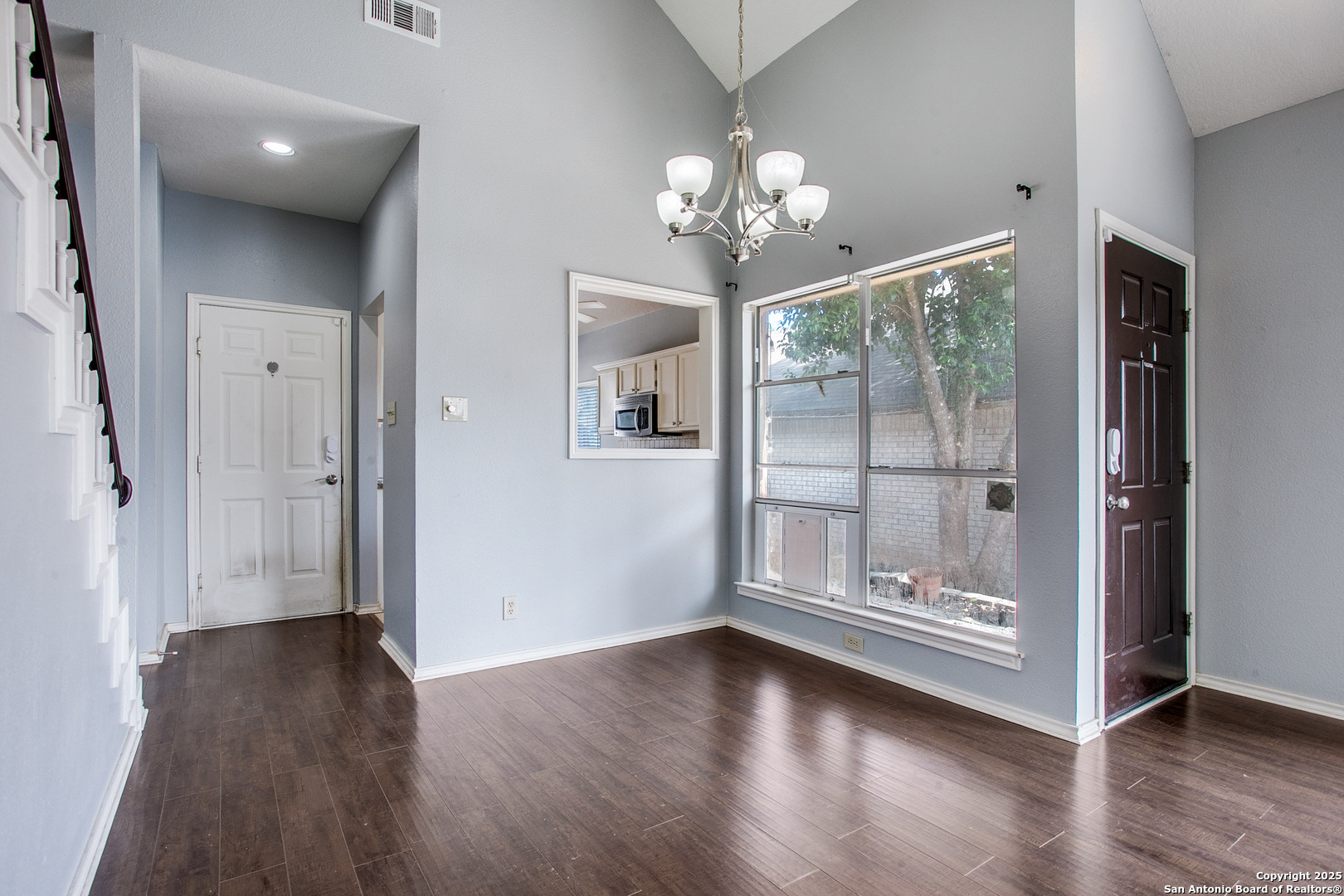 5834 Spring Crossing San Antonio, TX 78247 - Photo 5 of 29 wooden floor in an empty room with a window