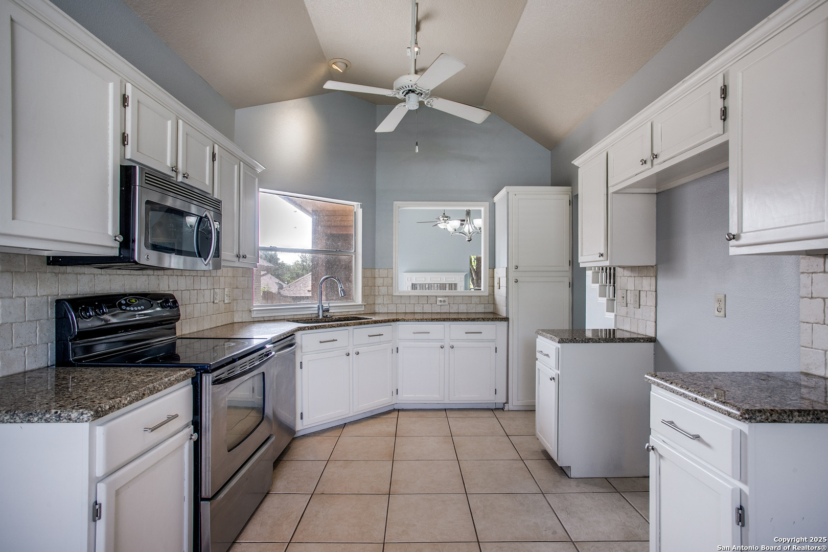 5834 Spring Crossing San Antonio, TX 78247 - Photo 10 of 29 a kitchen with stainless steel appliances granite countertop a stove a sink and a refrigerator