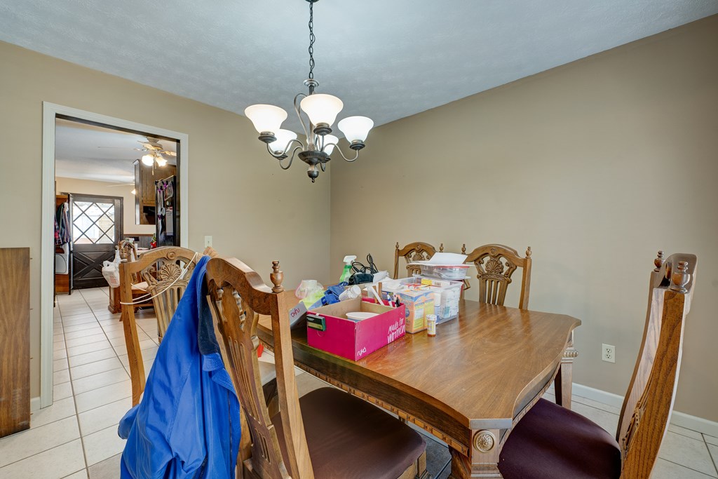 1676 Shoal Creek Road Dawsonville, GA 30534 - Photo 20 of 40 a view of a dining room with furniture and wooden floor