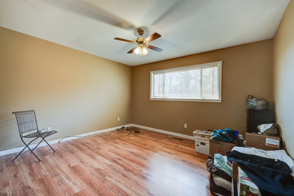 1676 Shoal Creek Road Dawsonville, GA 30534 - Photo 28 of 40 a bedroom with a bed and a window