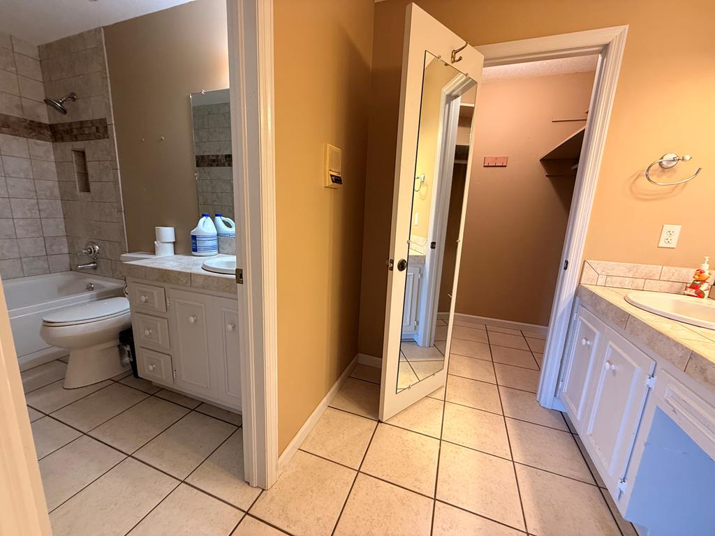1676 Shoal Creek Road Dawsonville, GA 30534 - Photo 39 of 40 a bathroom with a sink a toilet and shower