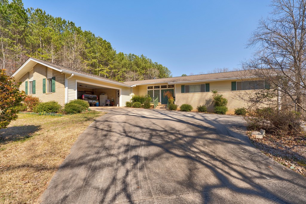 1676 Shoal Creek Road Dawsonville, GA 30534 - Photo 10 of 40 a front view of a house with a yard