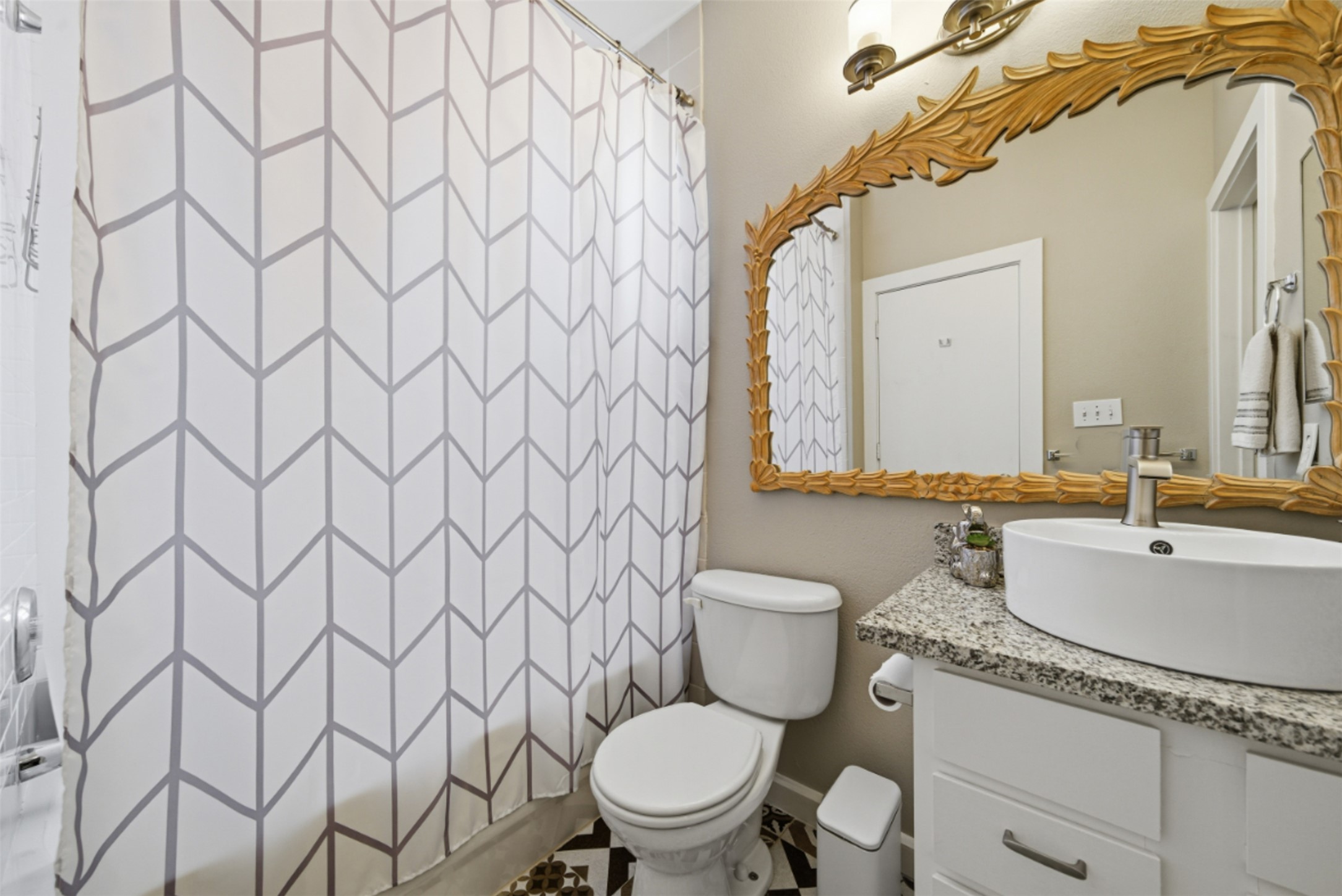 1201 Grove Boulevard, Unit 1304 Austin, TX 78741 - Photo 15 of 19 a bathroom with a granite countertop toilet sink and mirror