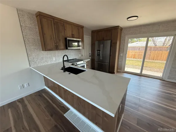 a room with wooden floor and window