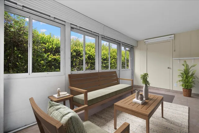 a living room with furniture and a potted plant