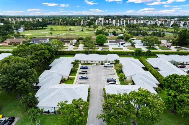 an aerial view of a house with a garden and swimming pool