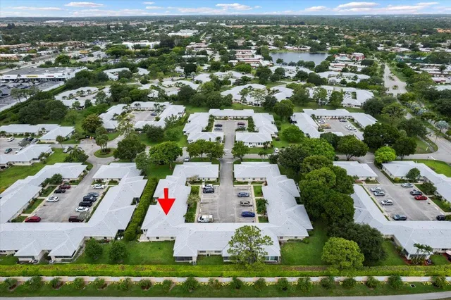 an aerial view of residential houses with outdoor space and parking