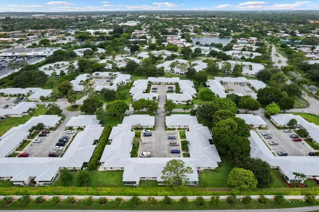 an aerial view of residential houses with outdoor space and street view