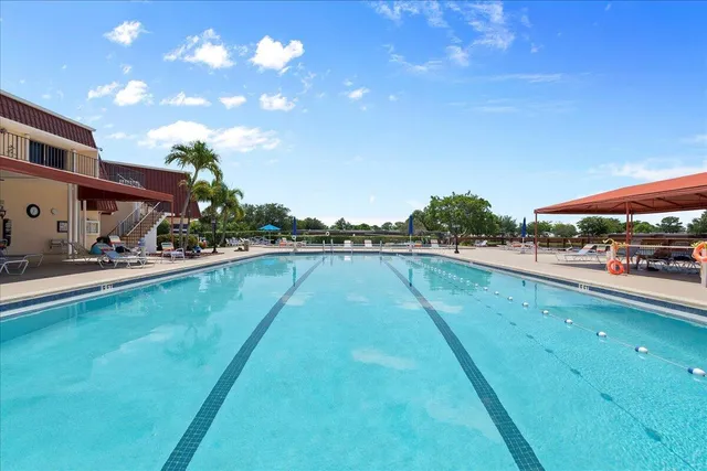 a view of swimming pool with outdoor seating and a pathway