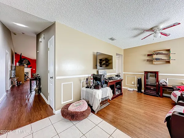 a kitchen with sink a refrigerator and chairs