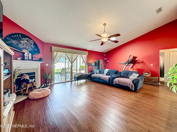 a bedroom with a bed and a flat tv screen on dresser