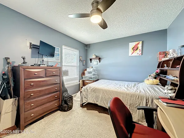a bedroom with a bed and a television