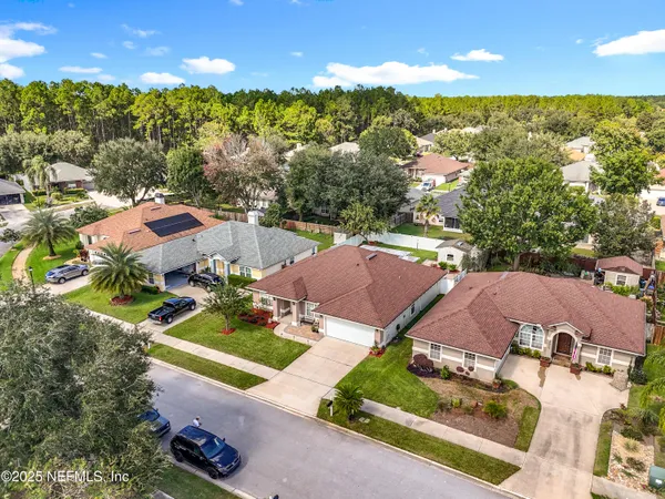 an aerial view of a house with garden space and street view