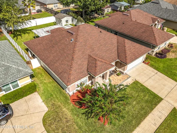 a aerial view of a house with garden and a sitting area