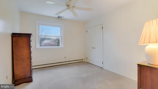 an empty room with windows and closet
