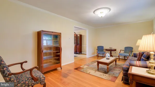 a living room with furniture a window and a flat screen tv