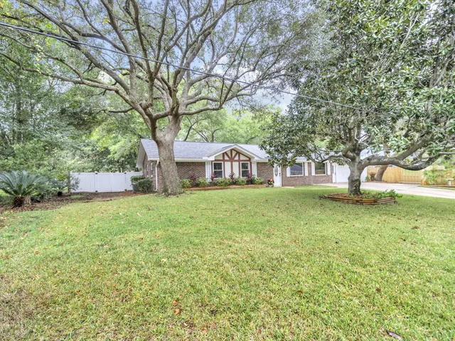 a kitchen with granite countertop white cabinets stainless steel appliances and a sink