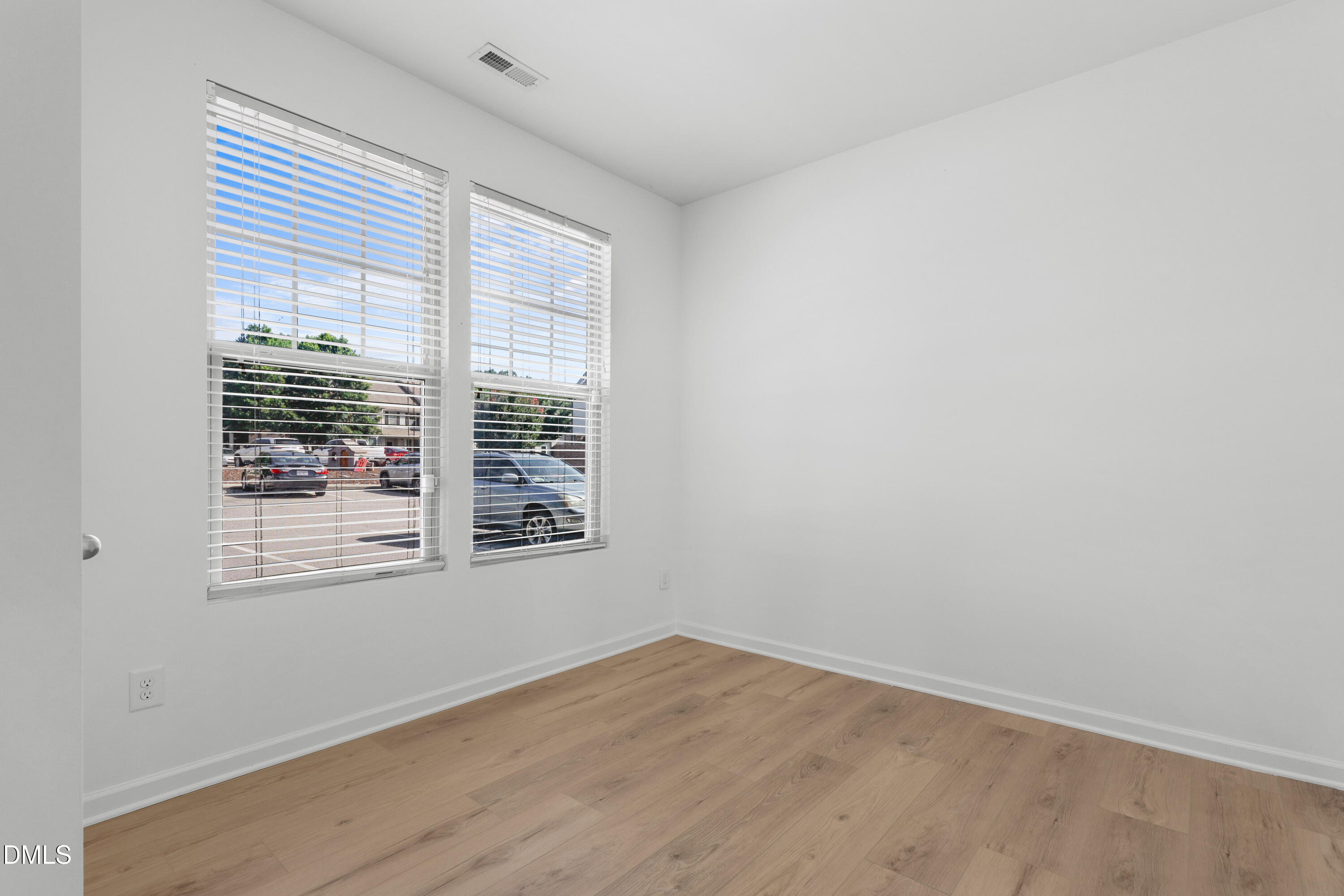 4400 Hillsgrove Road Wake Forest, NC 27587 - Photo 15 of 49 a view of an empty room with wooden floor and a window