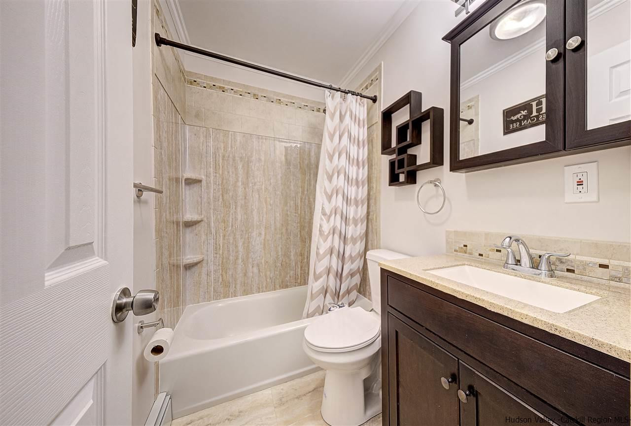 2 Colonial Road, Unit 146 Beacon, NY 12508 - Photo 13 of 13 a bathroom with a bathtub shower sink vanity mirror and toilet