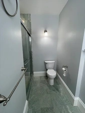 a bathroom with a toilet and a shower