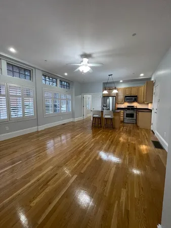 a living room with furniture and kitchen view