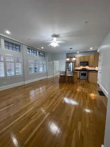 a living room with furniture and kitchen view