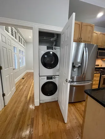 a kitchen with a sink a refrigerator and cabinets