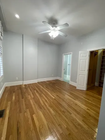 a view of an empty room and wooden floor
