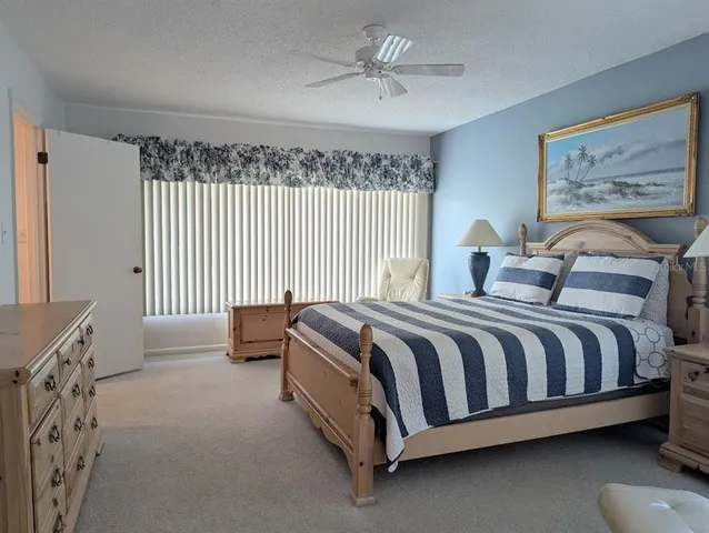 a spacious bedroom with a bed and a chandelier