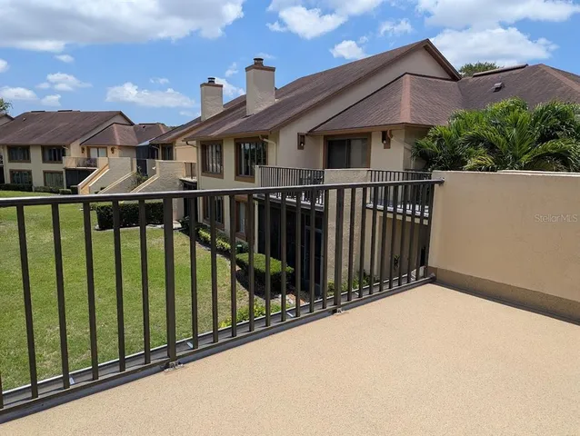 a view of a house with wooden fence