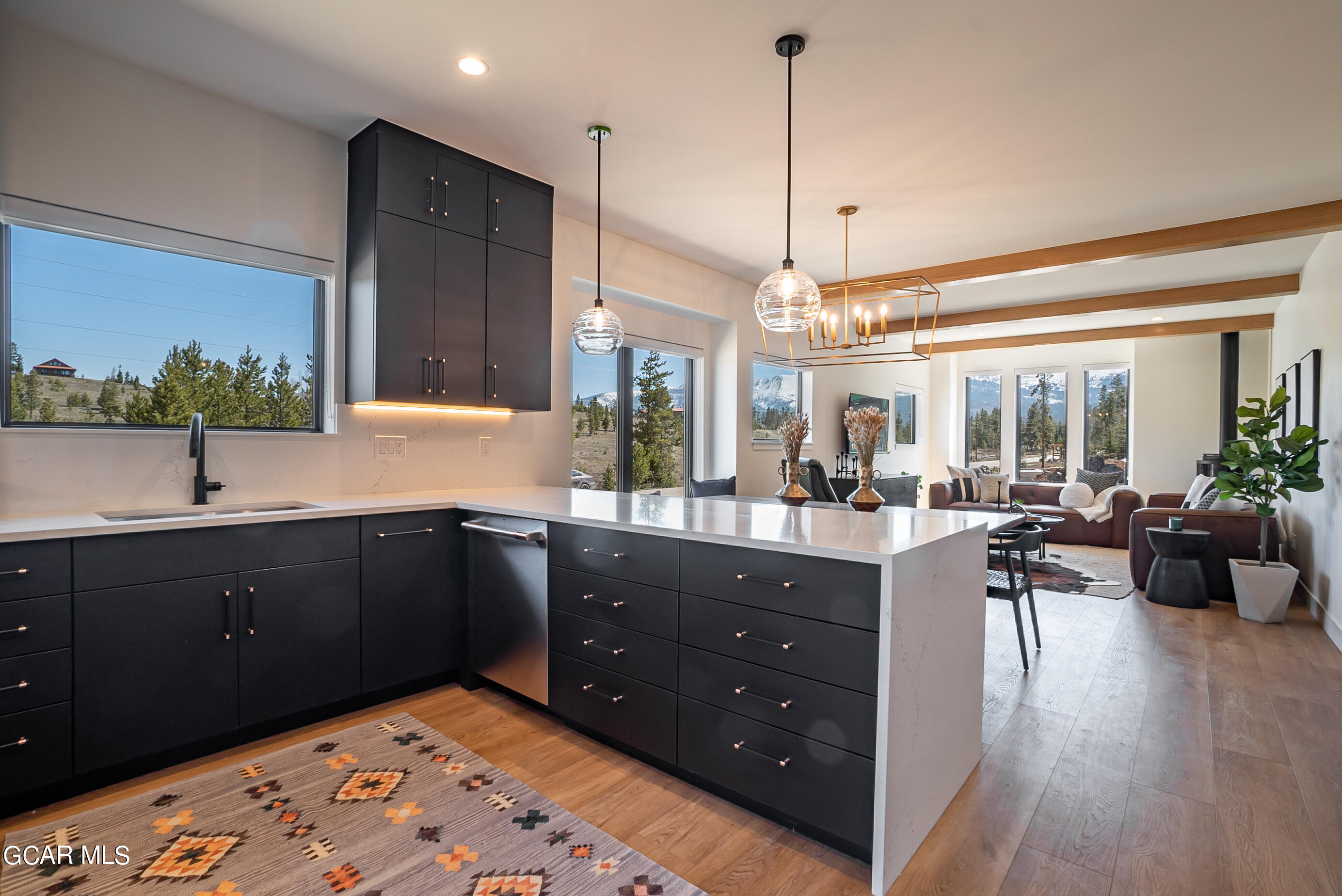1066 Gcr 8 Tabernash, CO 80478 - Photo 12 of 46 a kitchen with stainless steel appliances granite countertop sink stove and wooden floor