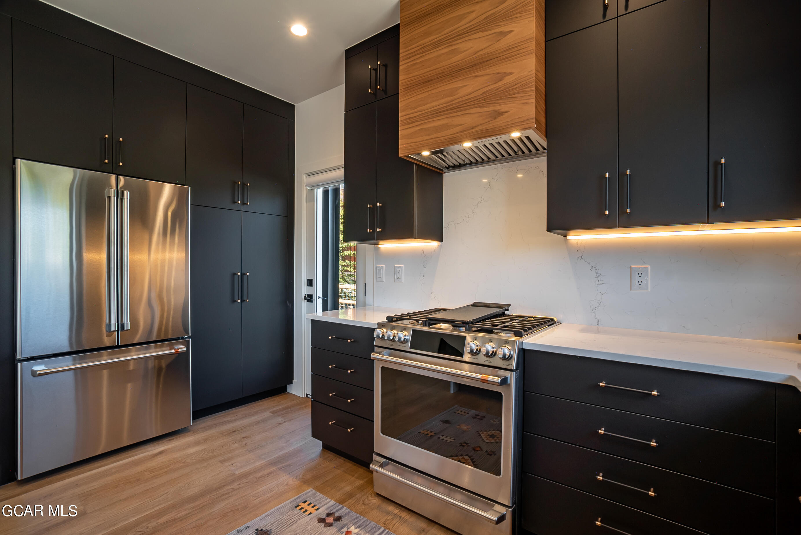 1066 Gcr 8 Tabernash, CO 80478 - Photo 14 of 46 a kitchen with a stove microwave and refrigerator