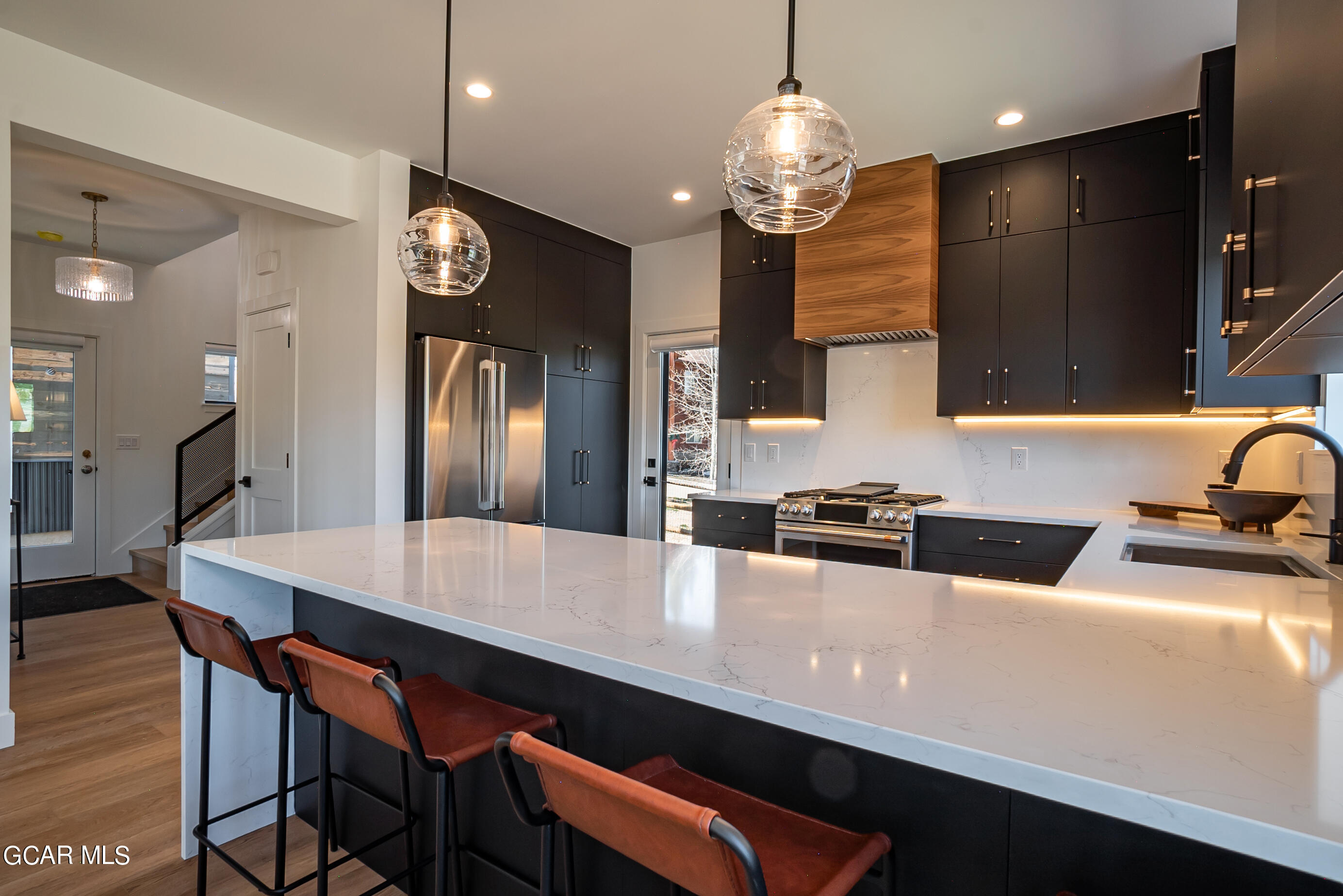 1066 Gcr 8 Tabernash, CO 80478 - Photo 15 of 46 a kitchen with stainless steel appliances a table chairs and a refrigerator