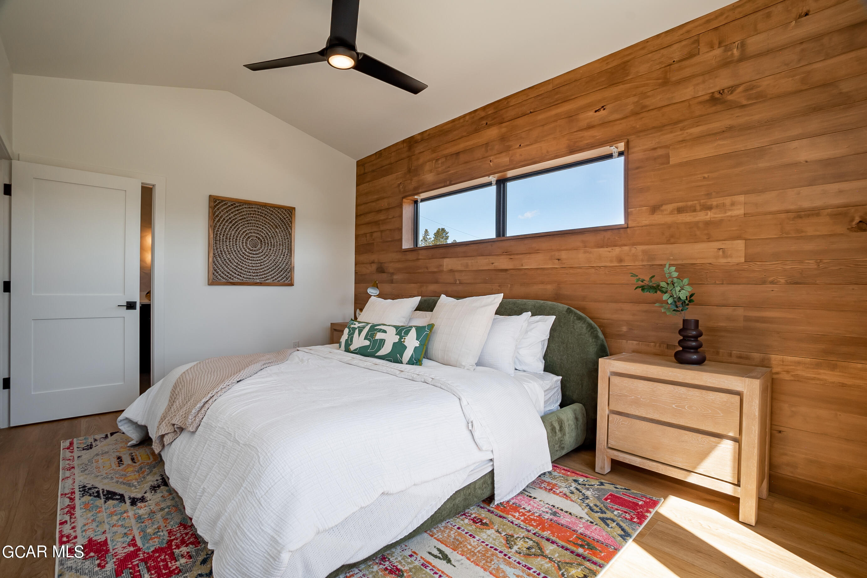 1066 Gcr 8 Tabernash, CO 80478 - Photo 19 of 46 a bedroom with a bed and a chandelier