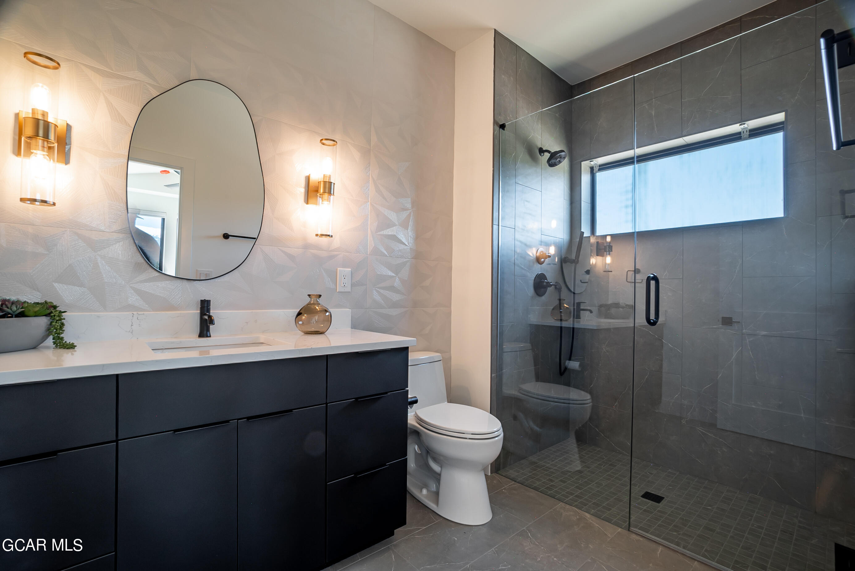 1066 Gcr 8 Tabernash, CO 80478 - Photo 20 of 46 a bathroom with a toilet sink a mirror and shower