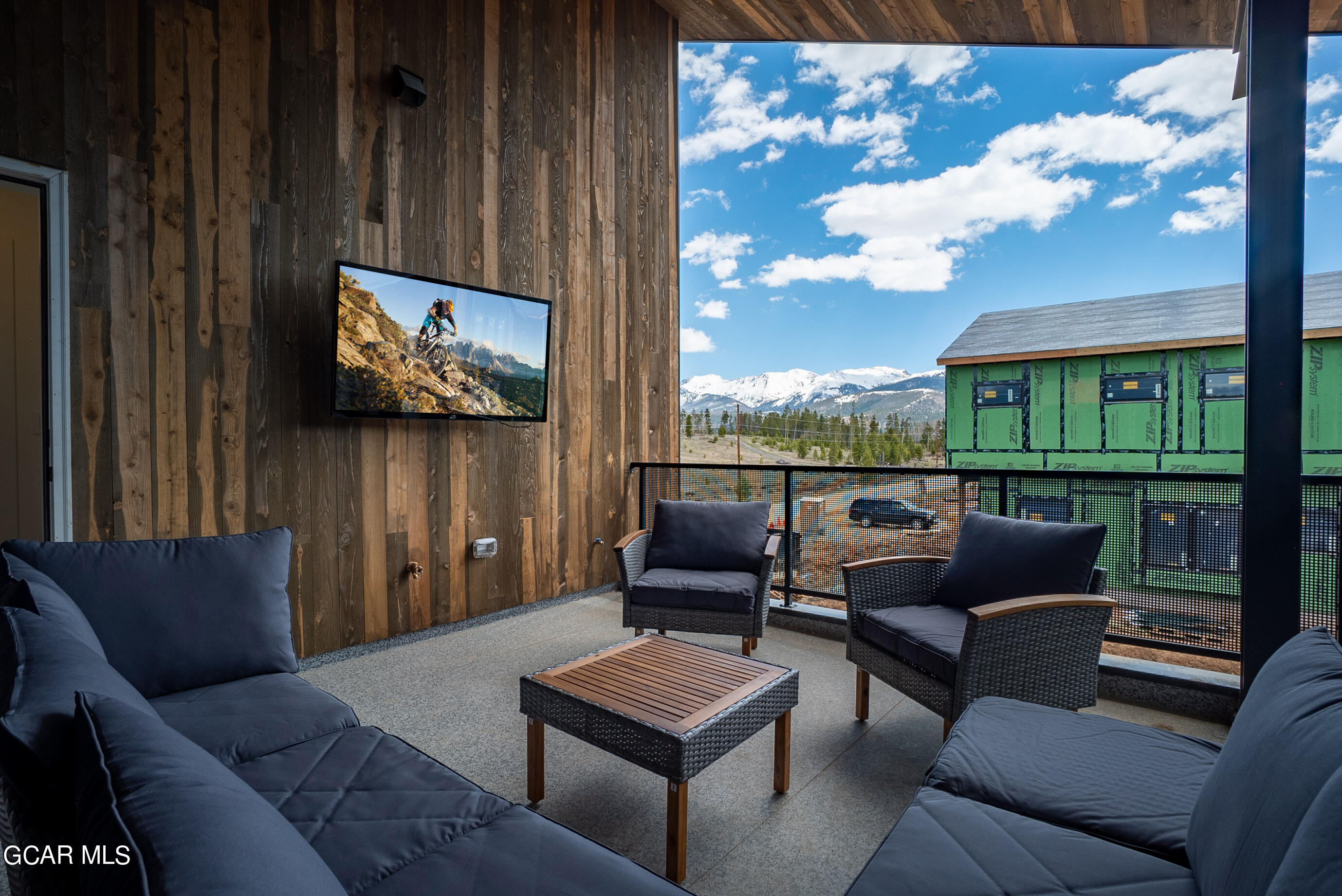 1066 Gcr 8 Tabernash, CO 80478 - Photo 30 of 46 a living room with furniture a flat screen tv and a floor to ceiling window