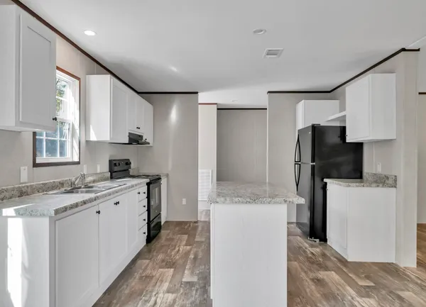 a kitchen with a sink stove and refrigerator