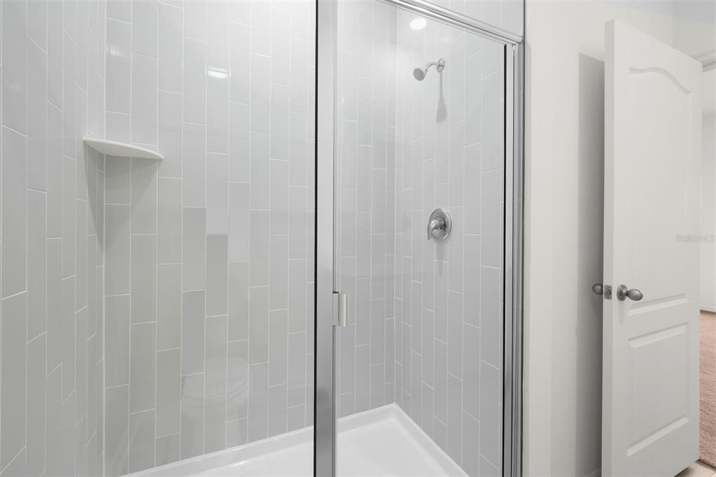 13303 Tula Loop Astatula, FL 34705 - Photo 13 of 18 a bathroom with a shower