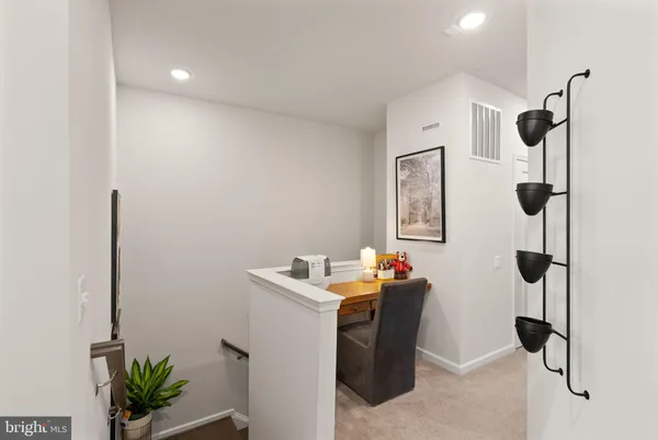 a hallway with front door wooden floor and windows
