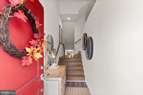 a view of entryway and hall with wooden floor
