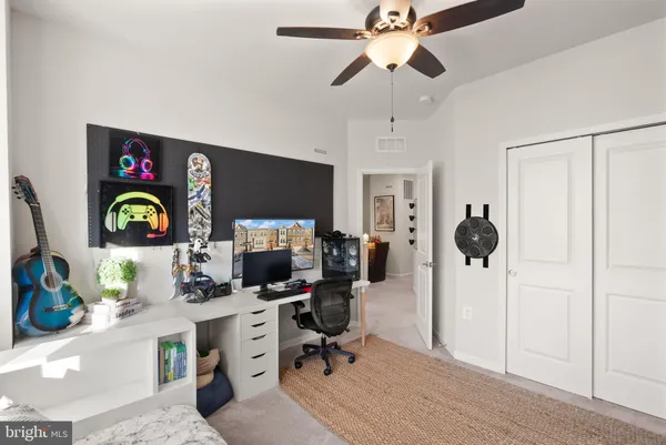 a bed room with a bed tv and a window