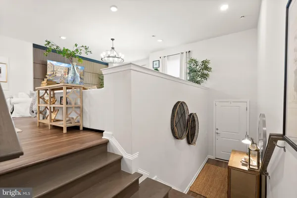a living room with furniture a chandelier and a flat screen tv