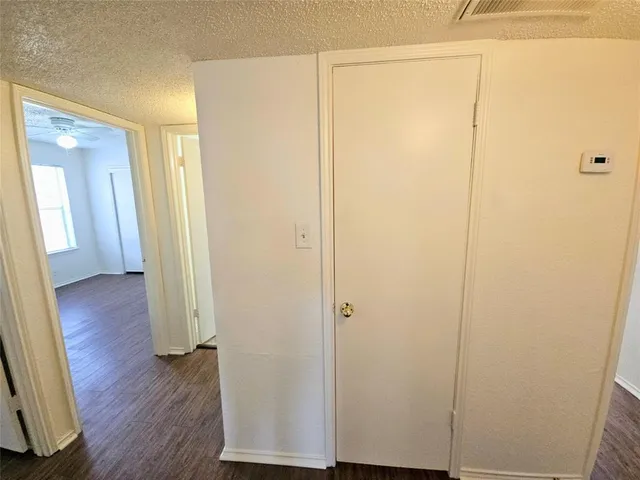a view of a room with wooden floor and a window