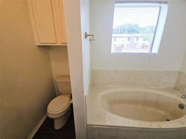 a bath tub sitting in a bathroom next to a window