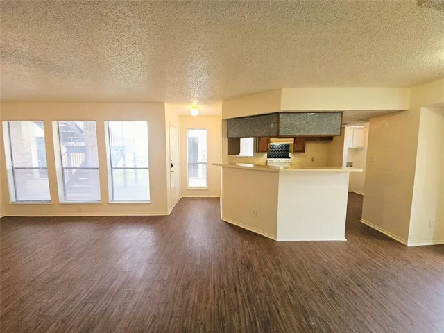 an empty room with a window and a ceiling fan