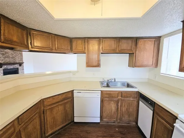 a view of a room with wooden floor and a window