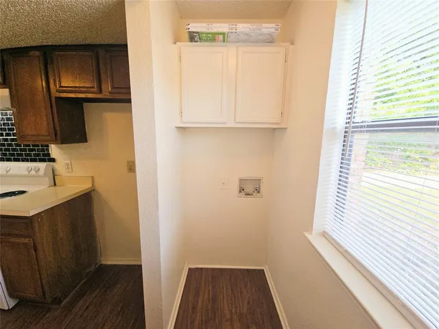 a kitchen with a sink a stove and cabinets