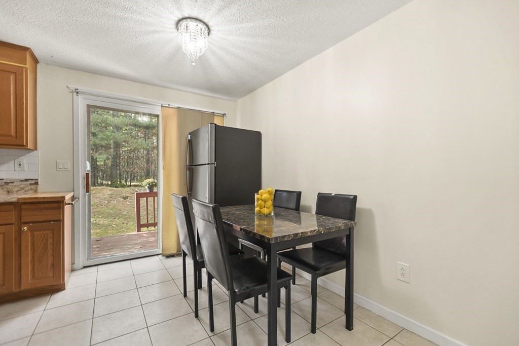 10 Groton Road, Unit B3 Westford, MA 01886 - Photo 8 of 34 a view of a dining room with furniture and a window